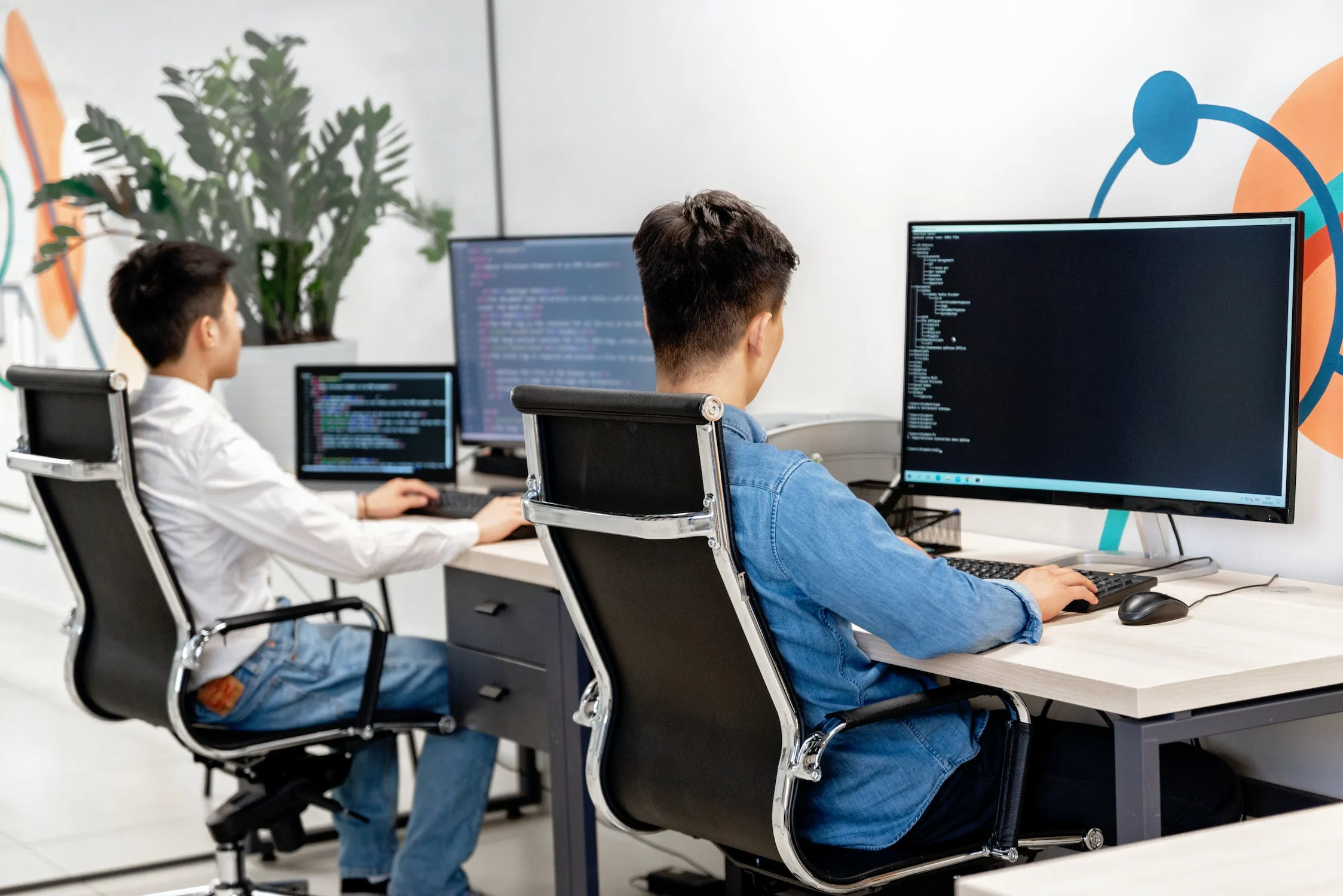 Two software engineers writing code