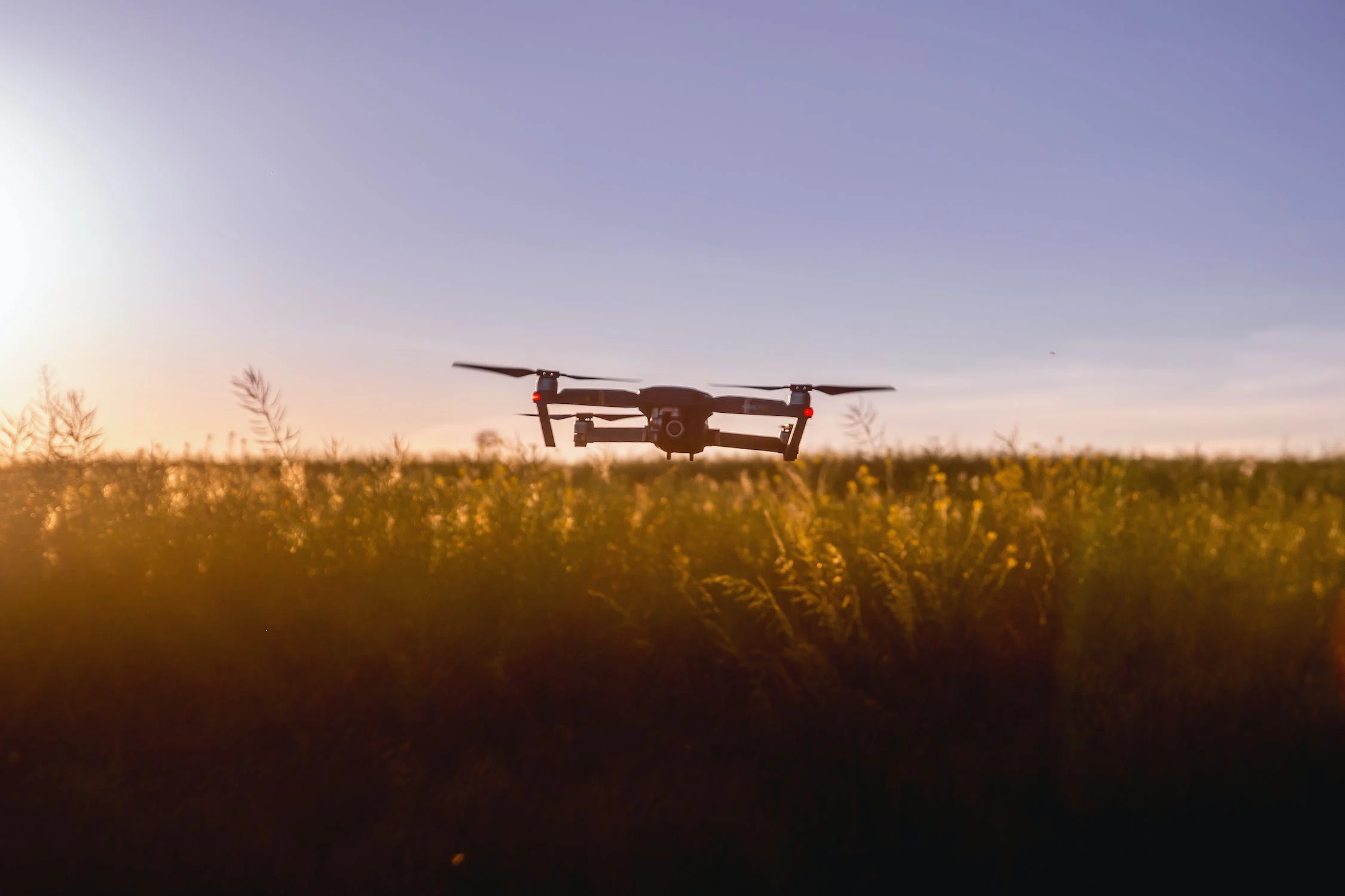 A drone flying above a farm field