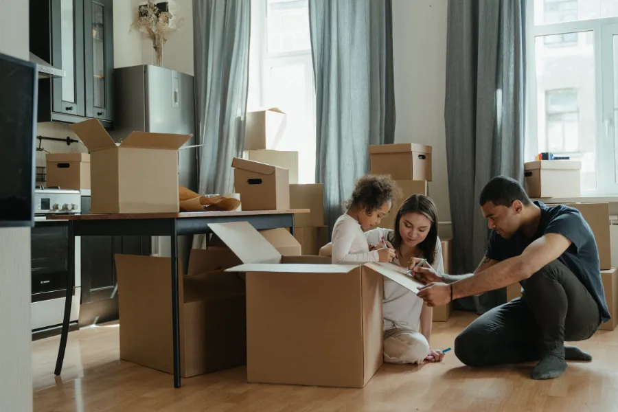 A young family moving in a house